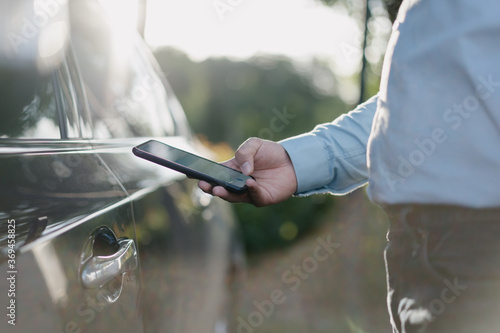 Business people unlock cars with smart phone