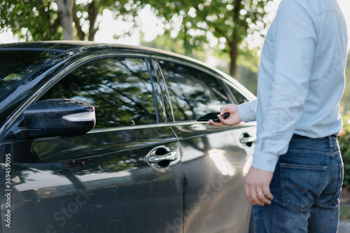 Business people unlock cars with smart phone