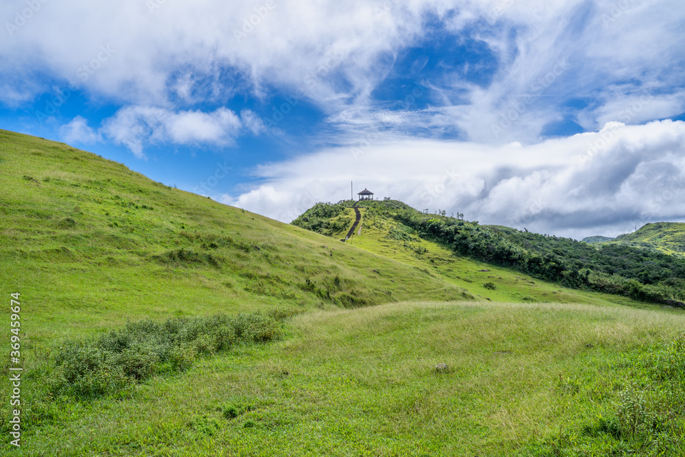 Fototapeta premium Beautiful grassland, prairie in Taoyuan Valley, Caoling Mountain Trail passes over the peak of Mt. Wankengtou in Taiwan.