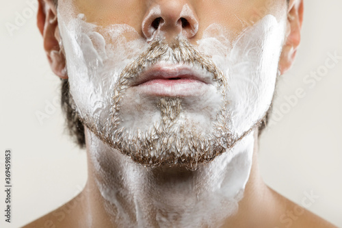 Man with a shaving cream on his face photo