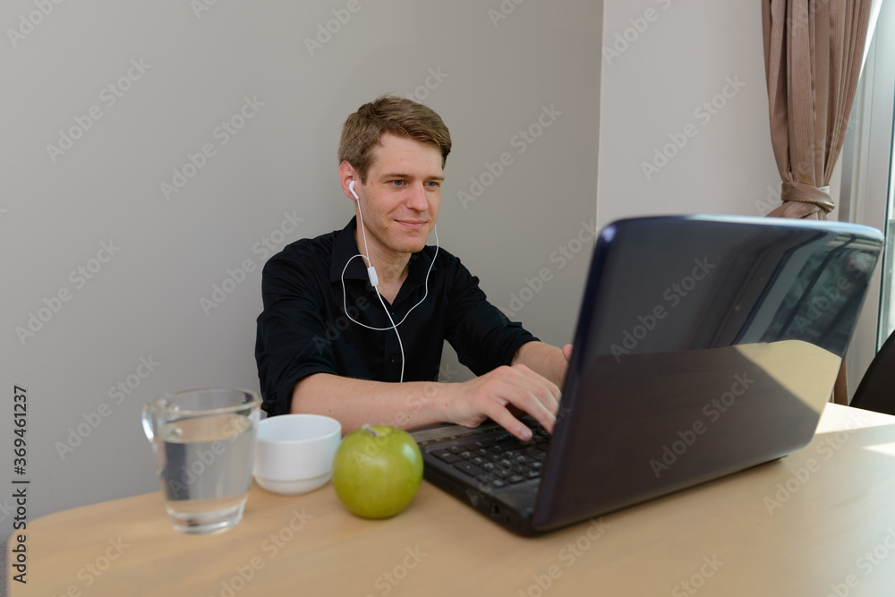 Portrait of young handsome blond businessman working from home Portrait of young handsome blond businessman working from home