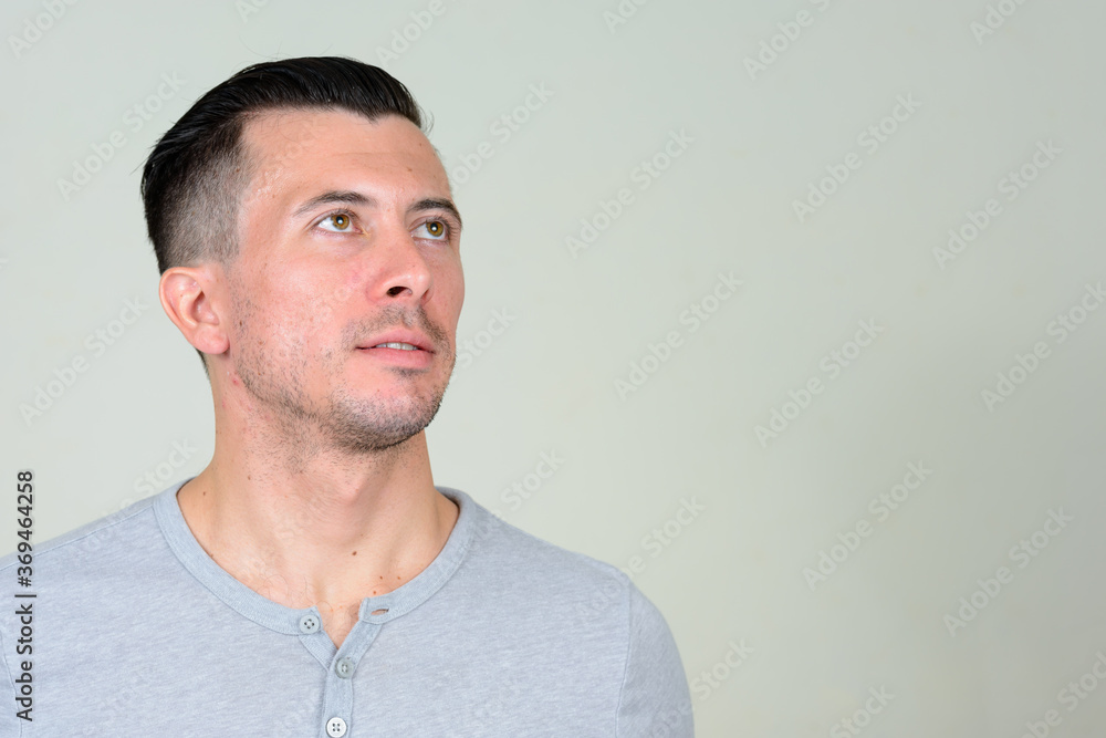 Fototapeta premium Portrait of young handsome man thinking and looking up
