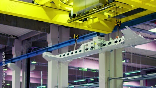 Overhead industrial crane moving inside an aircraft factory