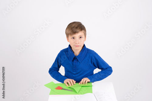 origami: the Boy listens carefully to the teacher, working on a