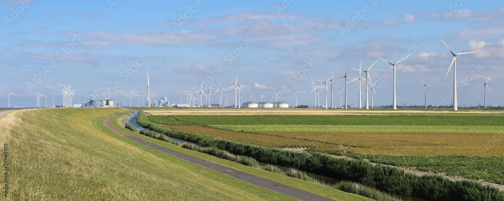 Panoramic summer view of the landscape and multi-fuel power station with wind turbines at Eemshaven, in Groningen, the Netherlands. Panoramic summer view of the landscape and multi-fuel power station with wind turbines at Eemshaven, in Groningen, the Netherlands.