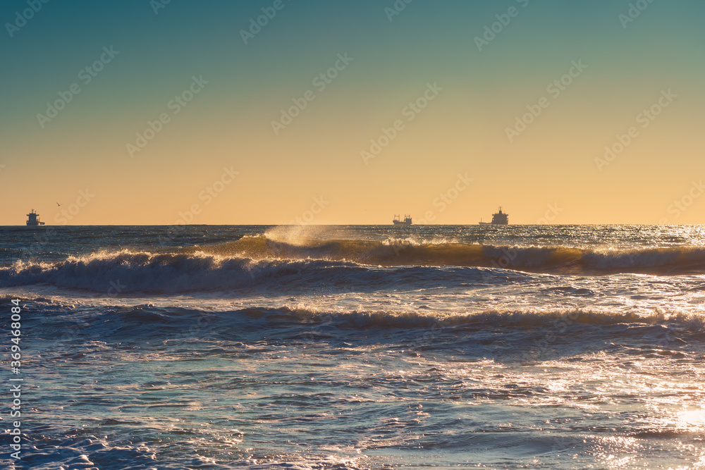 Cargo ship with containers in sunrise light