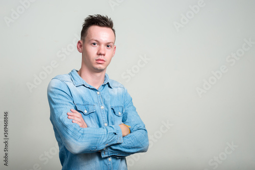 Portrait of young man against white background © Ranta Images