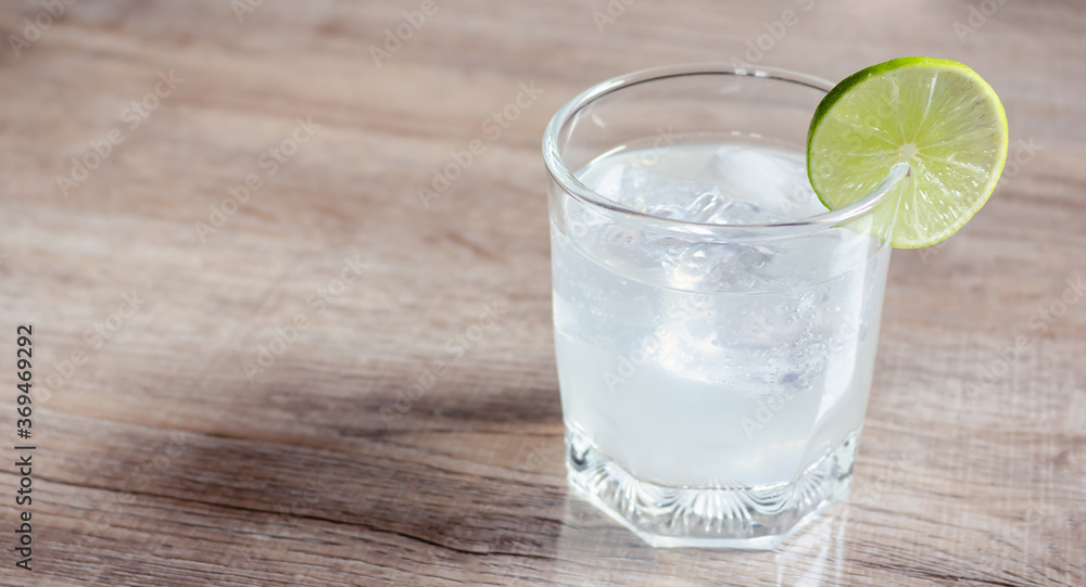 Lemon soda in clear glass on wooden table Lemon soda in clear glass on wooden table