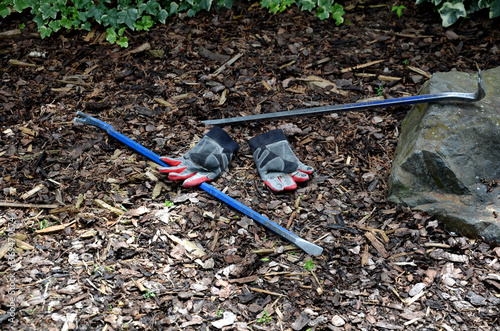 tools for robbing apartments and houses called a crowbar. Two metal curved irons for removing windows, tiles, nails and the like. work gloves lie on the ground photo