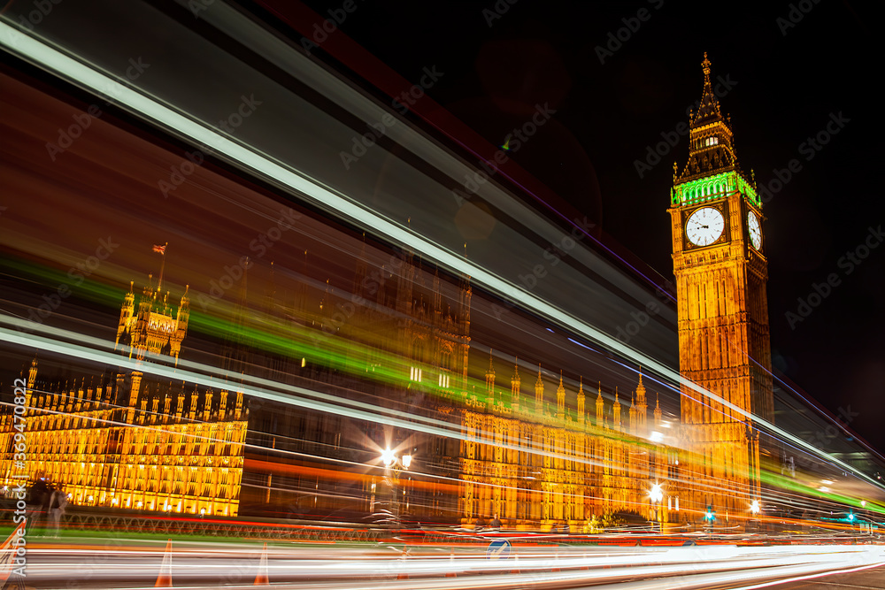 The Houses of Parliament in London England UK at night with Big Ben and light trails from passing vehicles and is a popular tourism travel destination visitor attraction of the city stock photo
