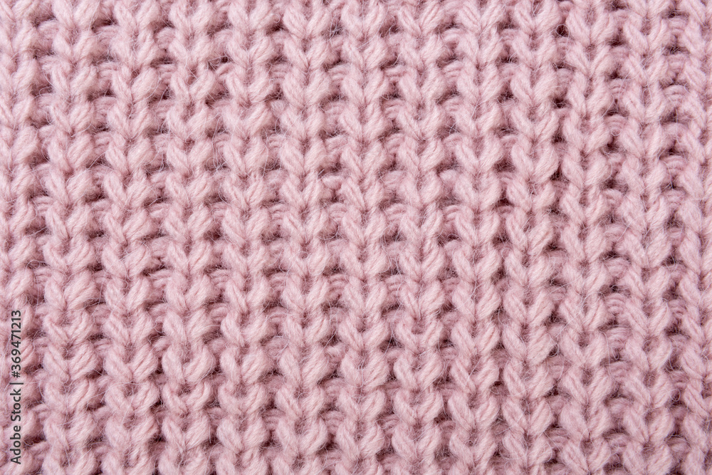 pink knitted fabric close-up, with coarse knit, textured background pink knitted fabric close-up, with coarse knit, textured background