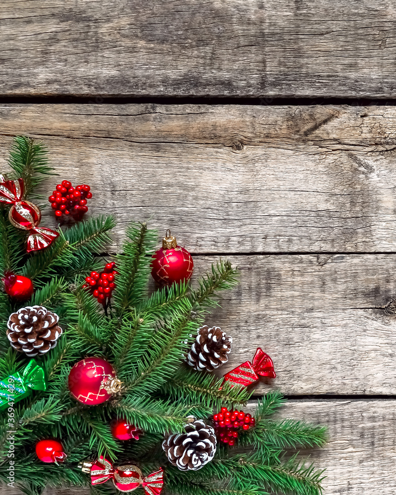 Christmas background, old wood texture, festive corner decorate. Pine fir leaf, cones, red golden balls, baubles, berries, candy, gift box. Xmas, New Year wallpaper, greeting card, top view flat lay. Christmas background, old wood texture, festive corner decorate. Pine fir leaf, cones, red golden balls, baubles, berries, candy, gift box. Xmas, New Year wallpaper, greeting card, top view flat lay.