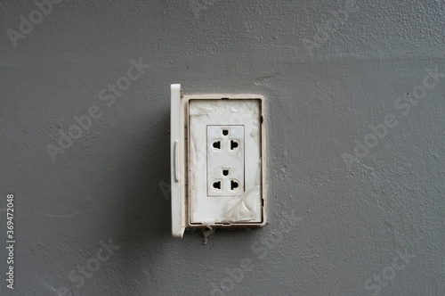 Asia plug socket. Plug socket on gray wall drak background