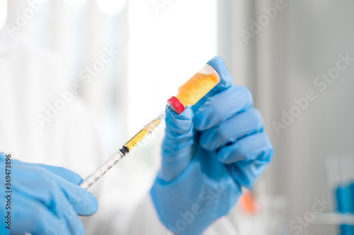 Professional doctors perform testing and analyzing samples of vaccines for immunization prevention and treatment from viral infections. Medical and health care concepts