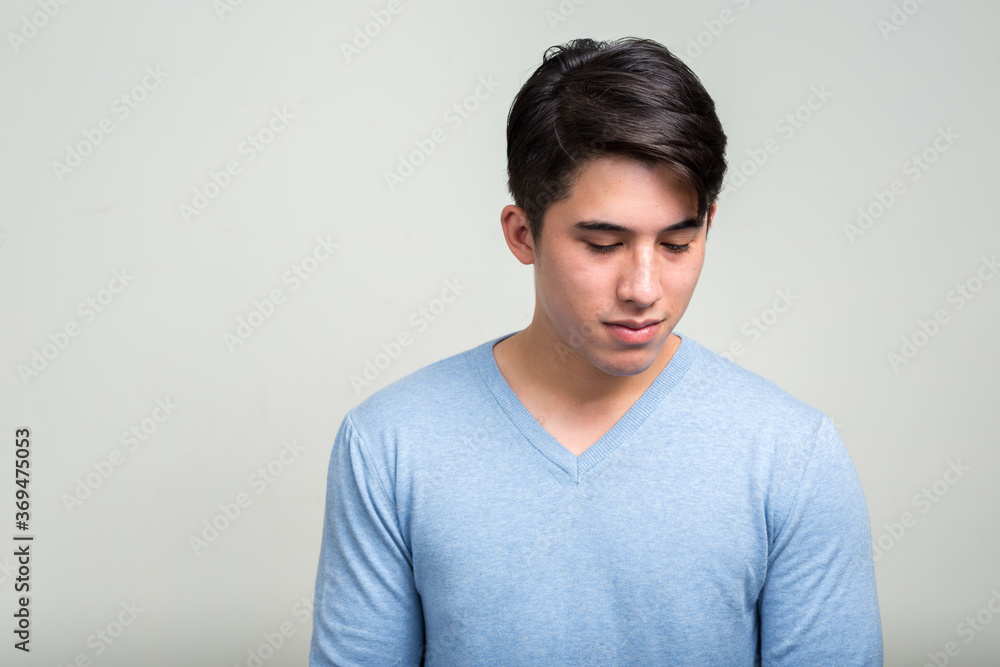 Portrait of young man thinking and looking down Portrait of young man thinking and looking down