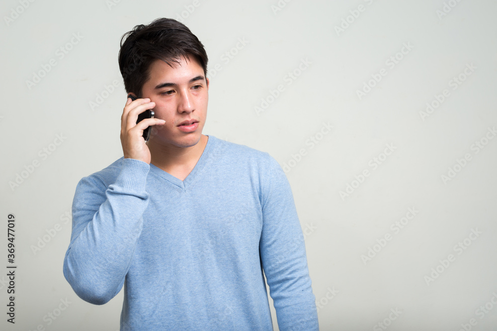 Portrait of young handsome man talking on the phone Portrait of young handsome man talking on the phone