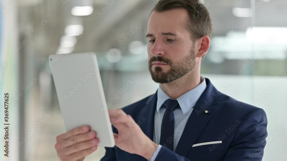 Portrait of Businessman using Digital Tablet Portrait of Businessman using Digital Tablet