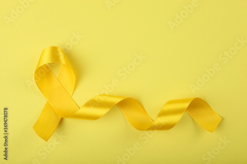 yellow ribbon symbolizing cancer in children top view 