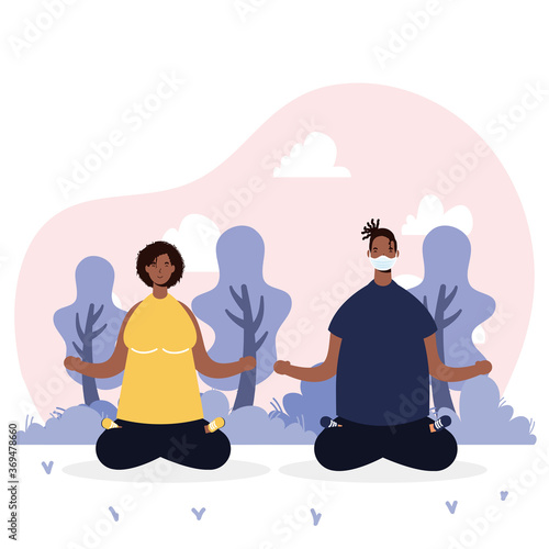 afro young couple wearing medical masks practicing yoga