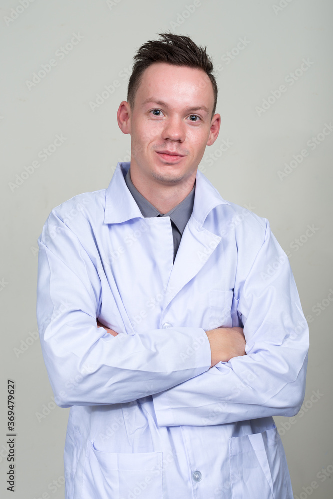 Portrait of young man doctor with arms crossed Portrait of young man doctor with arms crossed