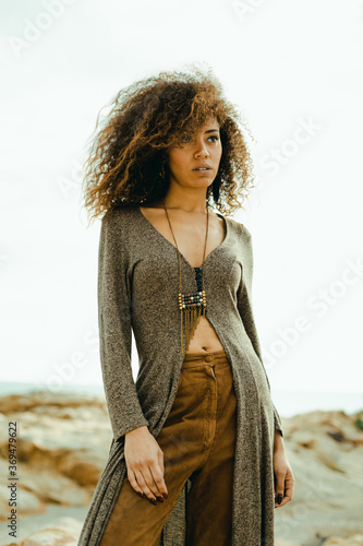  A beautiful fashionable young afro American woman posing outdoors in the shoreline
