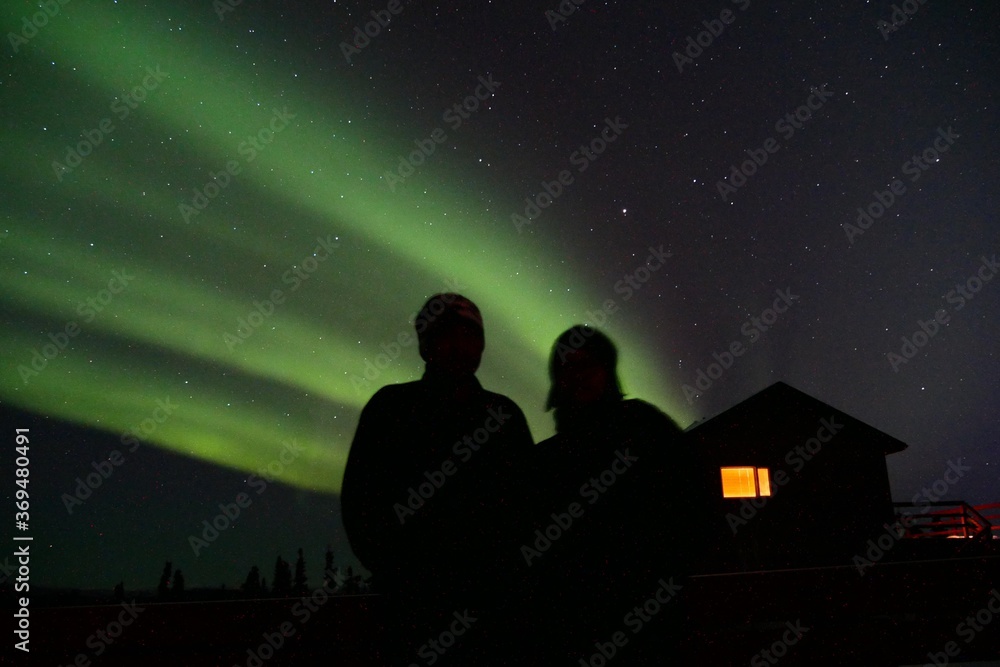 Silhouette of couple with norther light background in Fairbanks, Alaska