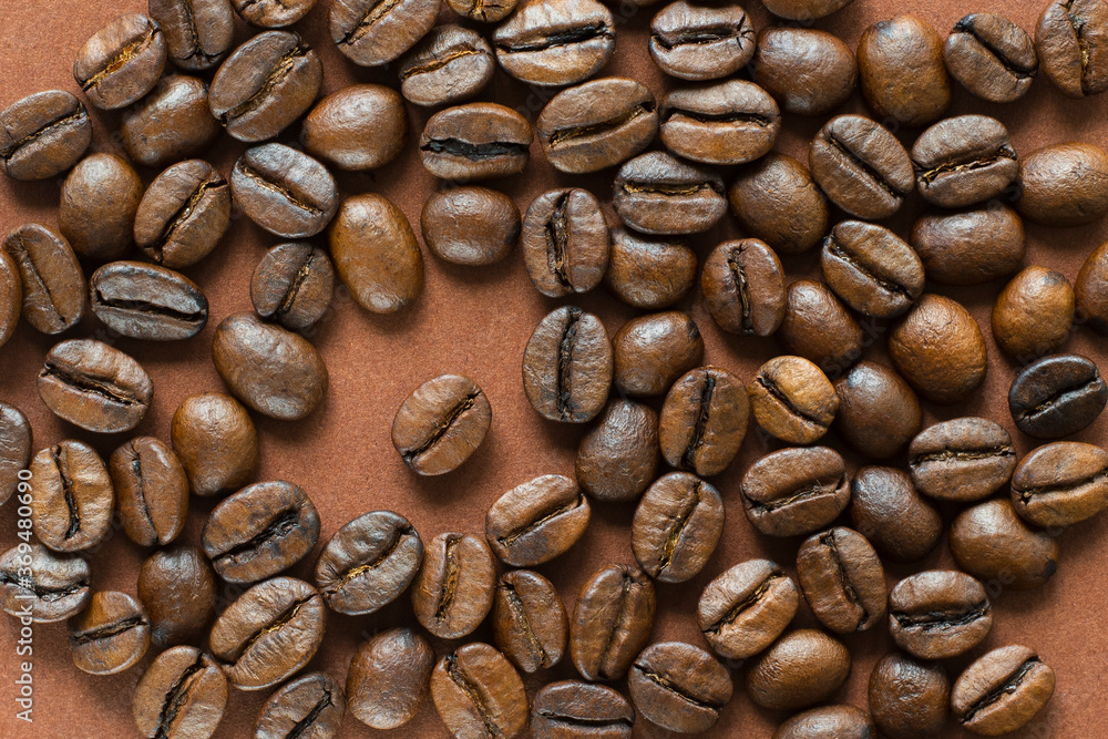 Coffee beans on brown background close up Coffee beans on brown background close up