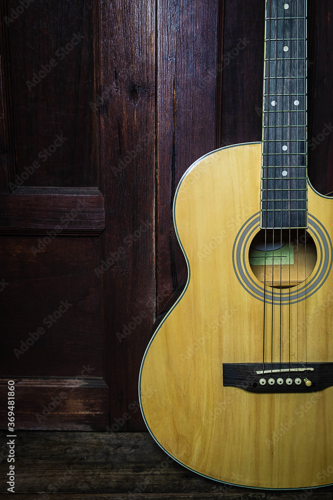 Fototapeta premium Classical guitar on old wooden background