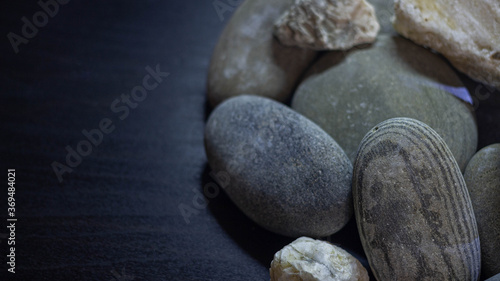 smooth sea stones on an ebony background