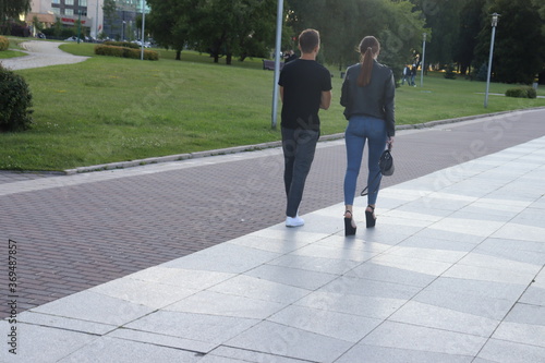 couple in stylish dress walking at european street