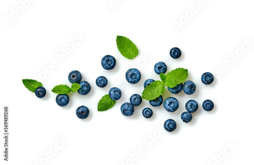 Blueberry isolated on white. Fresh blueberry closeup, healthy diet concept. Ripe organic bilberry, mint leaf creative composition. Juicy berries background, top view.
