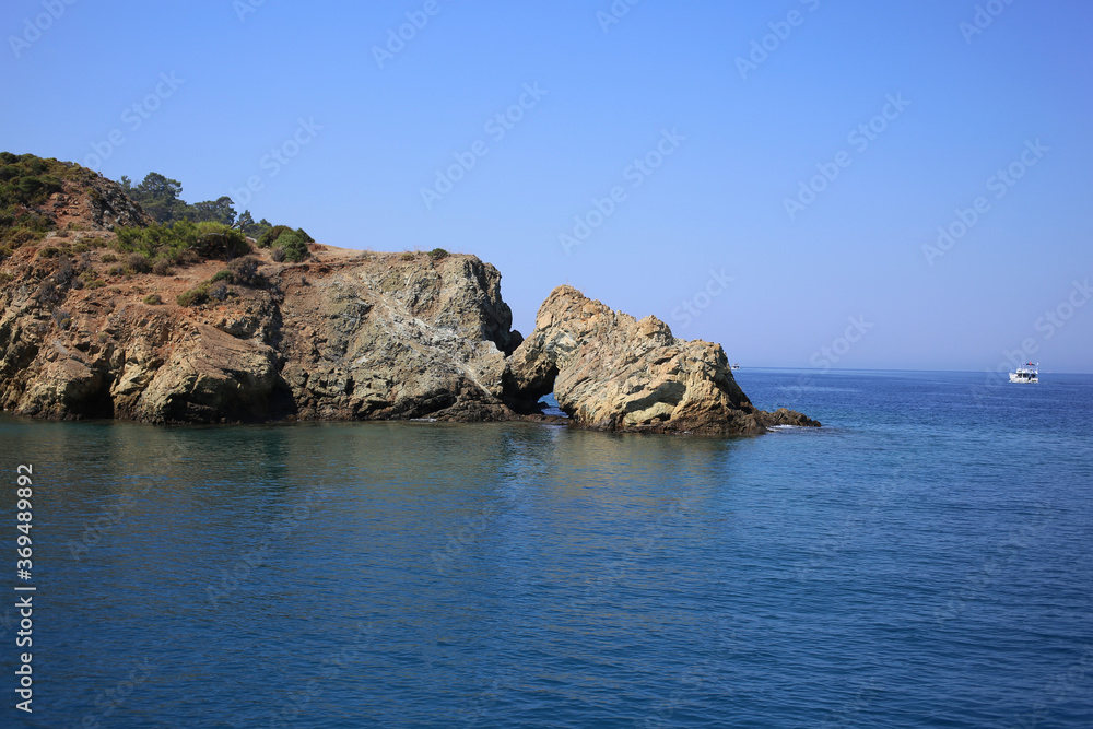 Rocks with a cave in the mediterranean sea in Turkey.