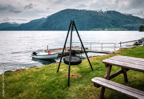 Obraz na płótnie grill tripod on the shore of the fjord