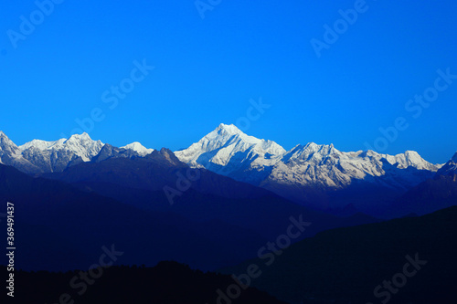A panoramic view of Mt Kanchenjunga with first rays of sunlight falling on it as seen from Hanuman top in Gantok Sikkim India