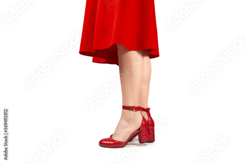 Woman in red dress and in retro red sandals on heels.