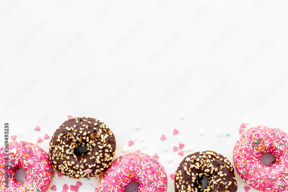 Donuts flat lay pattern on white background, top view Donuts flat lay pattern on white background, top view