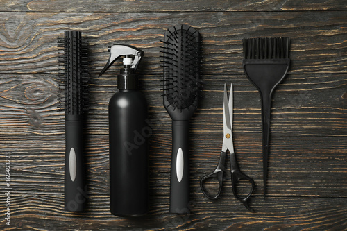 Flat lay with hairdresser accessories on wooden background