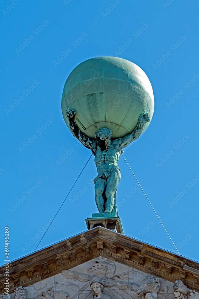 Amsterdam, Netherlands - April 20, 2020: Statue of Atlas on the Royal Palace Amsterdam