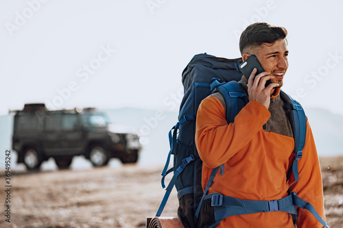 Young caucasian man traveller using his smartphone