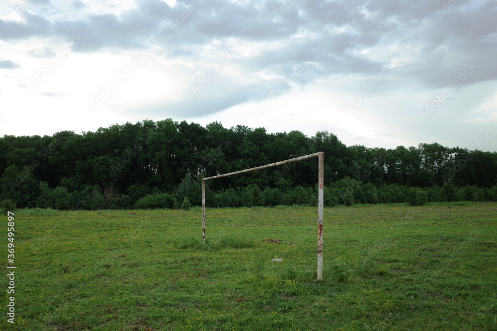 Football goal post in the middle of a poor quality pitch used for amateur games in rural Romania