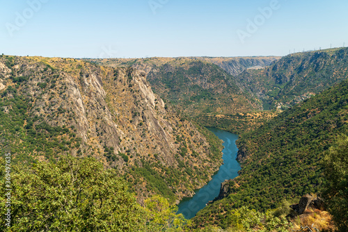 The river Duero and the high rocky mountains of the Arribes del Duero with the hydroelectric power station at the top being a tourist area in Spain