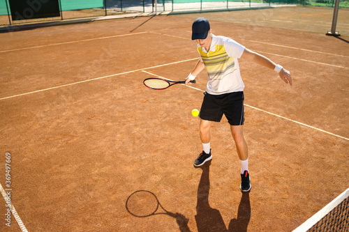 Young tennis player hitting the ball © Andrii 