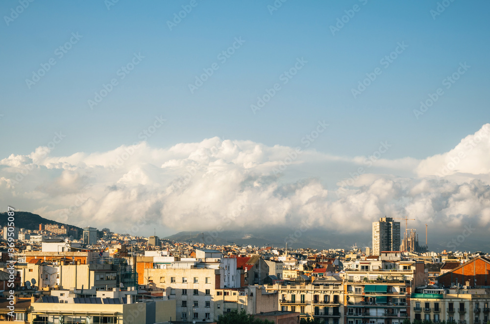 Clouds above Barcelona skyline at sunset, Spain