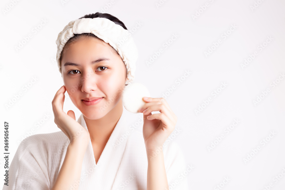 Pretty woman cleaning beautiful face by wiping, using cotton pads, cleansing lotion, facial toner. Attractive beautiful young lady has nice facial skin, bright facial skin. Facial skin care concept. Pretty woman cleaning beautiful face by wiping, using cotton pads, cleansing lotion, facial toner. Attractive beautiful young lady has nice facial skin, bright facial skin. Facial skin care concept.