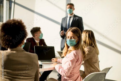 Group of business people have a meeting and working in office and wear masks as protection from corona virus