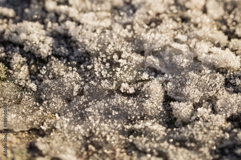 Ice crystals on the ground of a hill in Horton, Norway. Macro close-up of texture of ice formed on the rocks Ice crystals on the ground of a hill in Horton, Norway. Macro close-up of texture of ice formed on the rocks