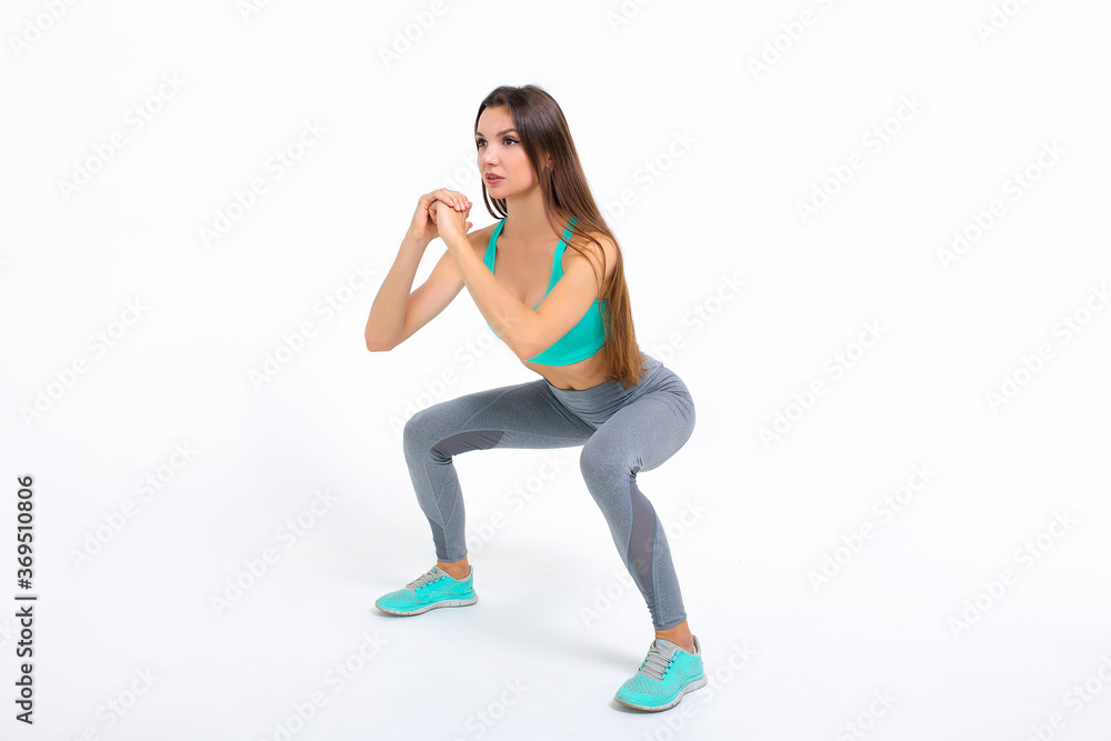 Sports girl doing workout on a white background