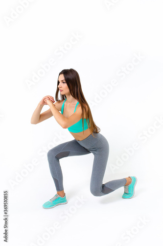 Fototapeta Naklejka Na Ścianę i Meble -  Sporty girl doing exercise on white background