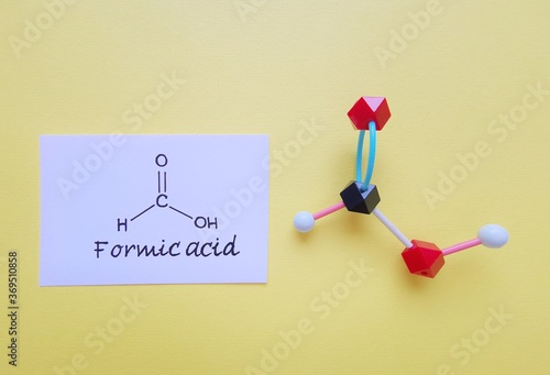 Molecular structure model and structural chemical formula of formic acid molecule. Formic acid (methanoic acid, HCOOH) is the simplest carboxylic acid, used in processing textiles and leather.