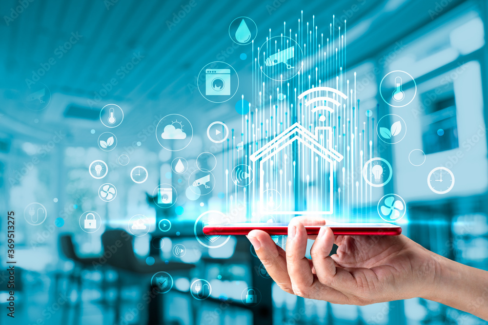 Man's hand hold mobile phone and using smart home application showing virtual screen. House control and Automation system technology of things Man's hand hold mobile phone and using smart home application showing virtual screen. House control and Automation system technology of things